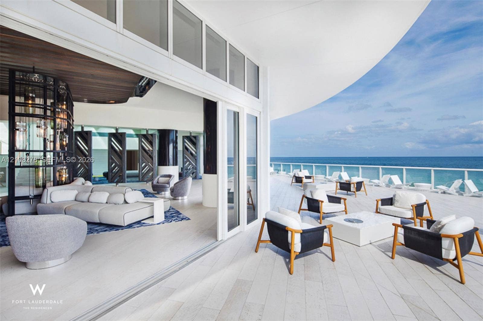 3101 Bayshore Drive, #701, Fort Lauderdale, FL 33304 Expansive covered balcony featuring white tile flooring, glass perimeter railing, and large multi-panel sliding glass doors