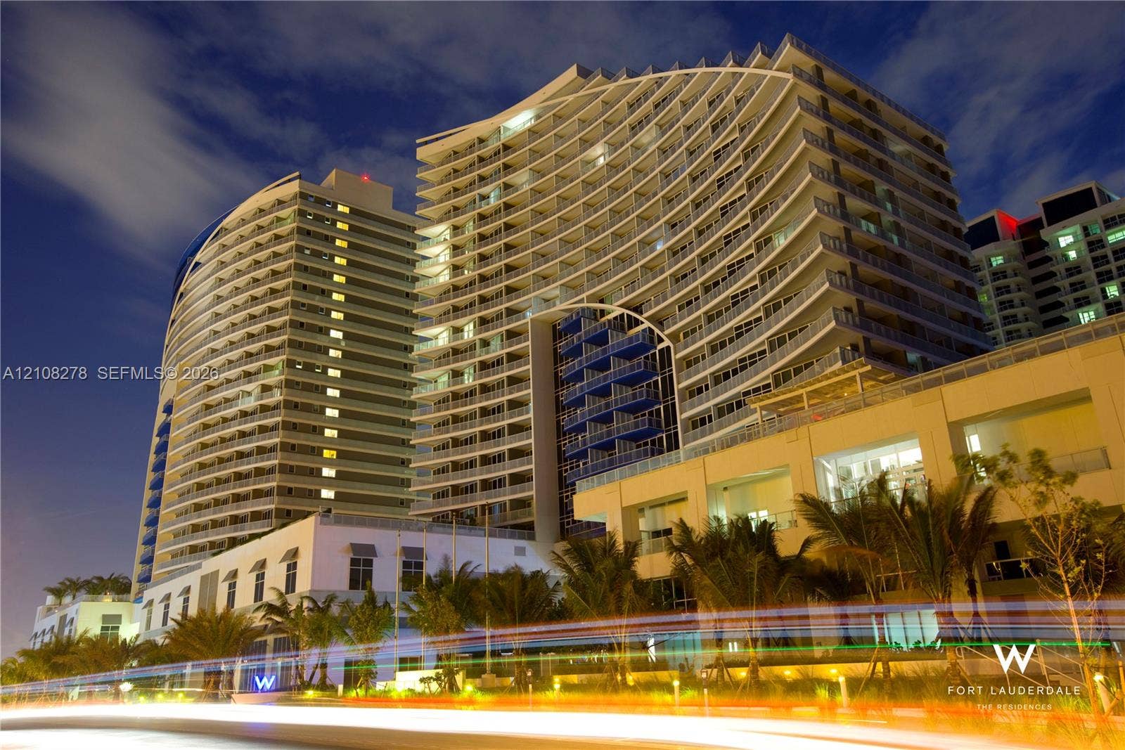 3101 Bayshore Drive, #701, Fort Lauderdale, FL 33304 Modern high-rise architectural facade featuring undulating balconies, expansive glass panels, and integrated recessed lighting