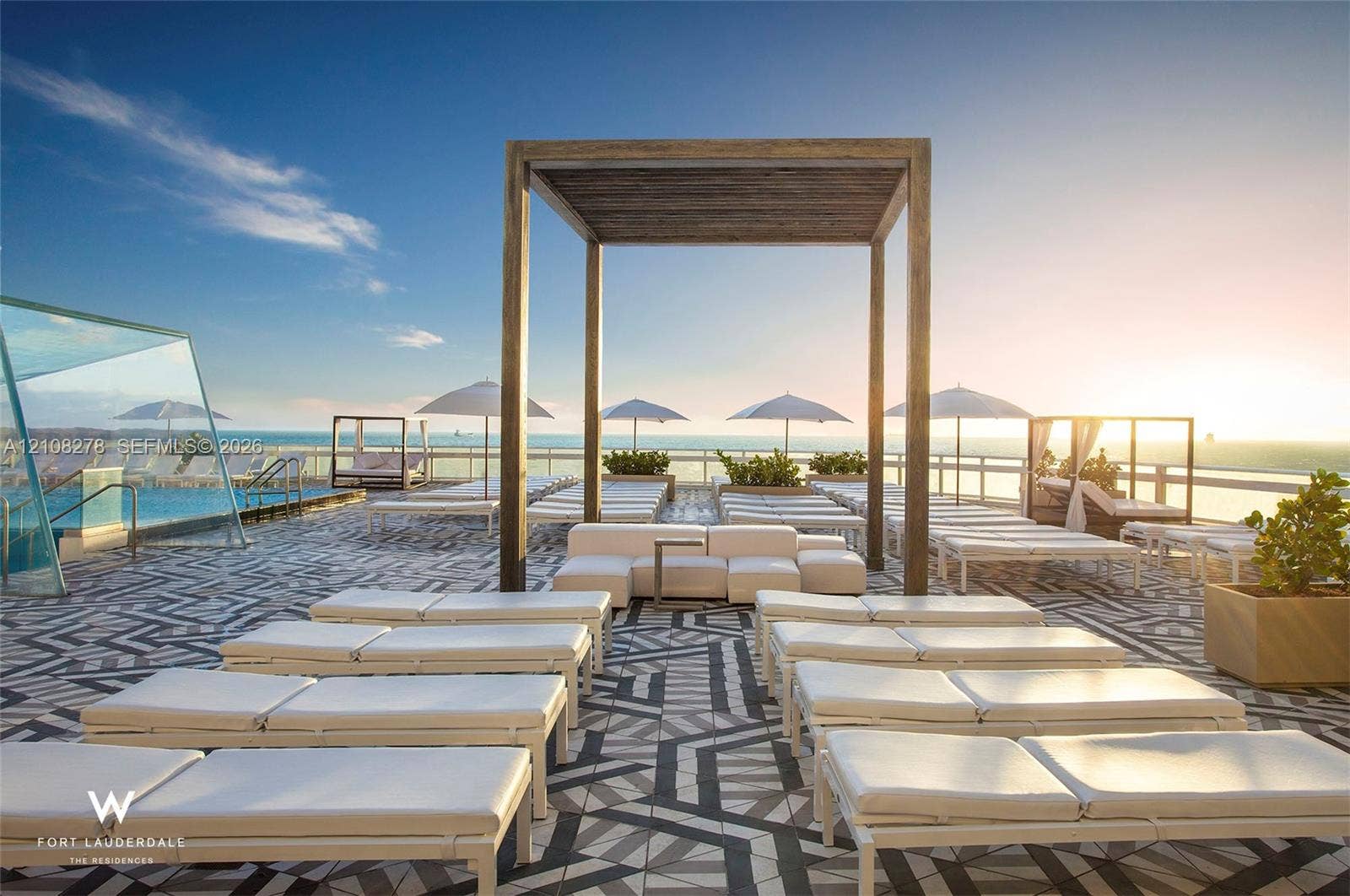 3101 Bayshore Drive, #701, Fort Lauderdale, FL 33304 Rooftop terrace featuring a swimming pool, glass-panel perimeter fencing, custom geometric-patterned hardscaping, and a large wood-finish pergola