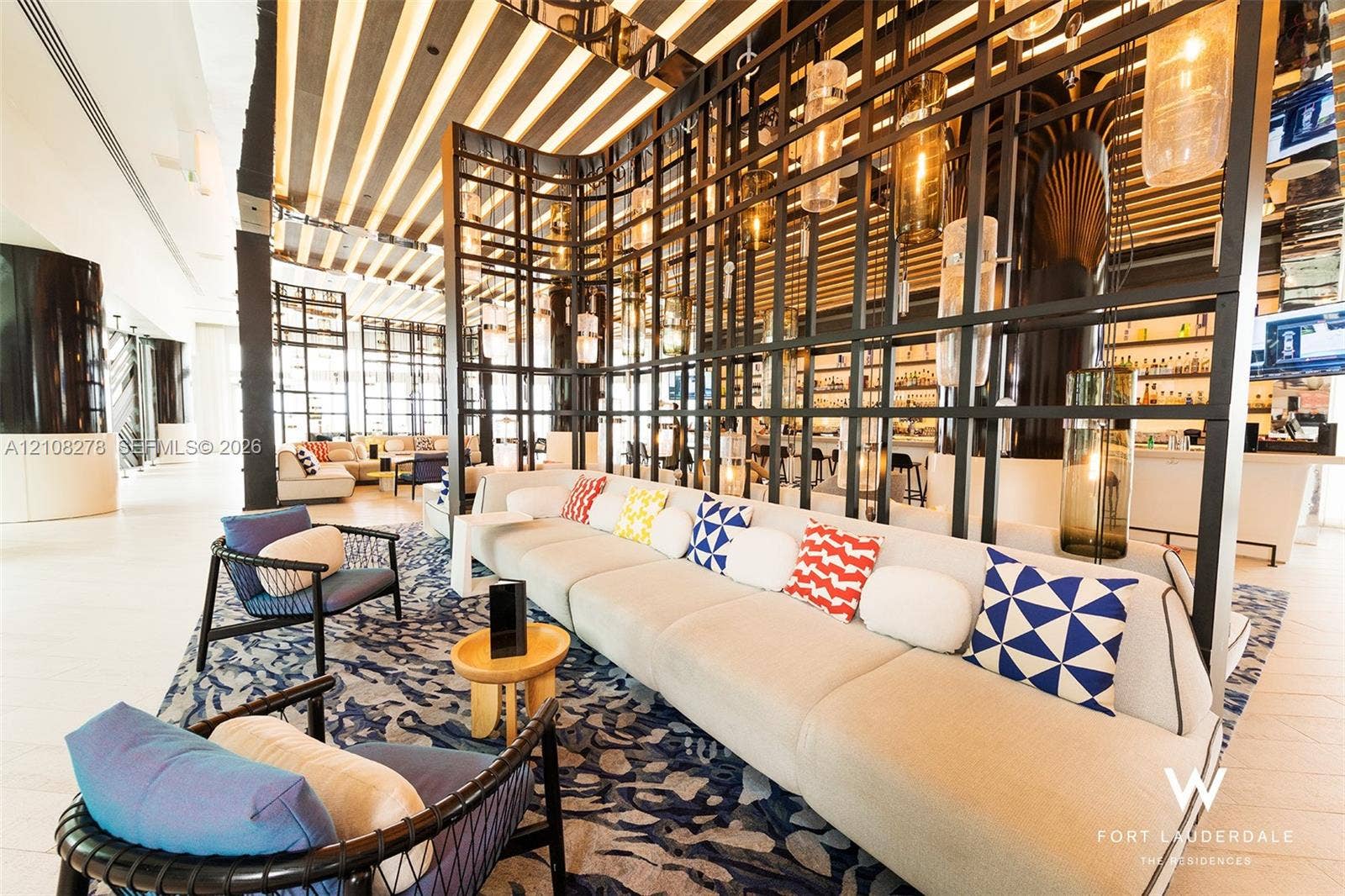3101 Bayshore Drive, #701, Fort Lauderdale, FL 33304 Architectural floor-to-ceiling metal grid room divider, linear ceiling paneling with integrated recessed lighting, large-format tile flooring, and custom tiered glass pendant fixtures