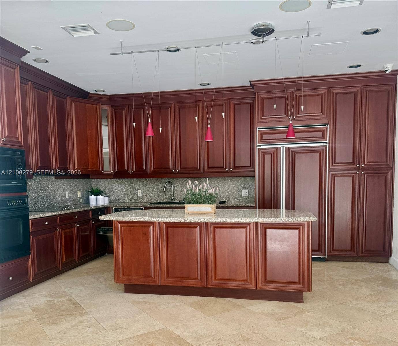 19424 39th Avenue, Sunny Isles Beach, Sunny Isles Beach, FL 33160 Custom wood-finish cabinetry, central island with stone countertop, integrated refrigerator, stone tile flooring, and recessed ceiling lighting