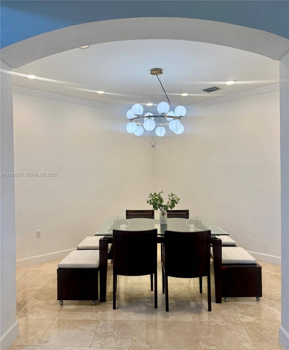 19424 39th Avenue, Sunny Isles Beach, Sunny Isles Beach, FL 33160 Arched entryway featuring polished stone flooring, recessed lighting, and a contemporary multi-globe chandelier