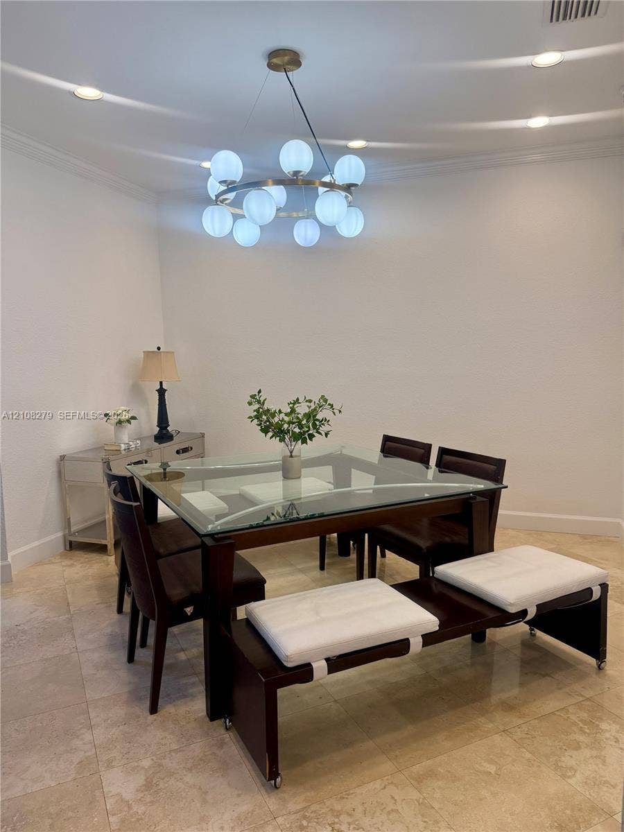 19424 39th Avenue, Sunny Isles Beach, Sunny Isles Beach, FL 33160 Circular multi-light chandelier, recessed lighting, and stone flooring