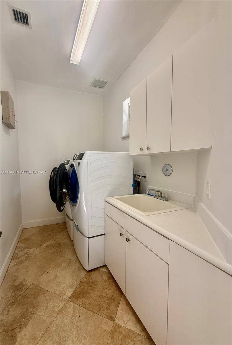 19424 39th Avenue, Sunny Isles Beach, Sunny Isles Beach, FL 33160 Utility room featuring tile flooring, white shaker-style cabinetry, a drop-in basin sink, and overhead fluorescent lighting