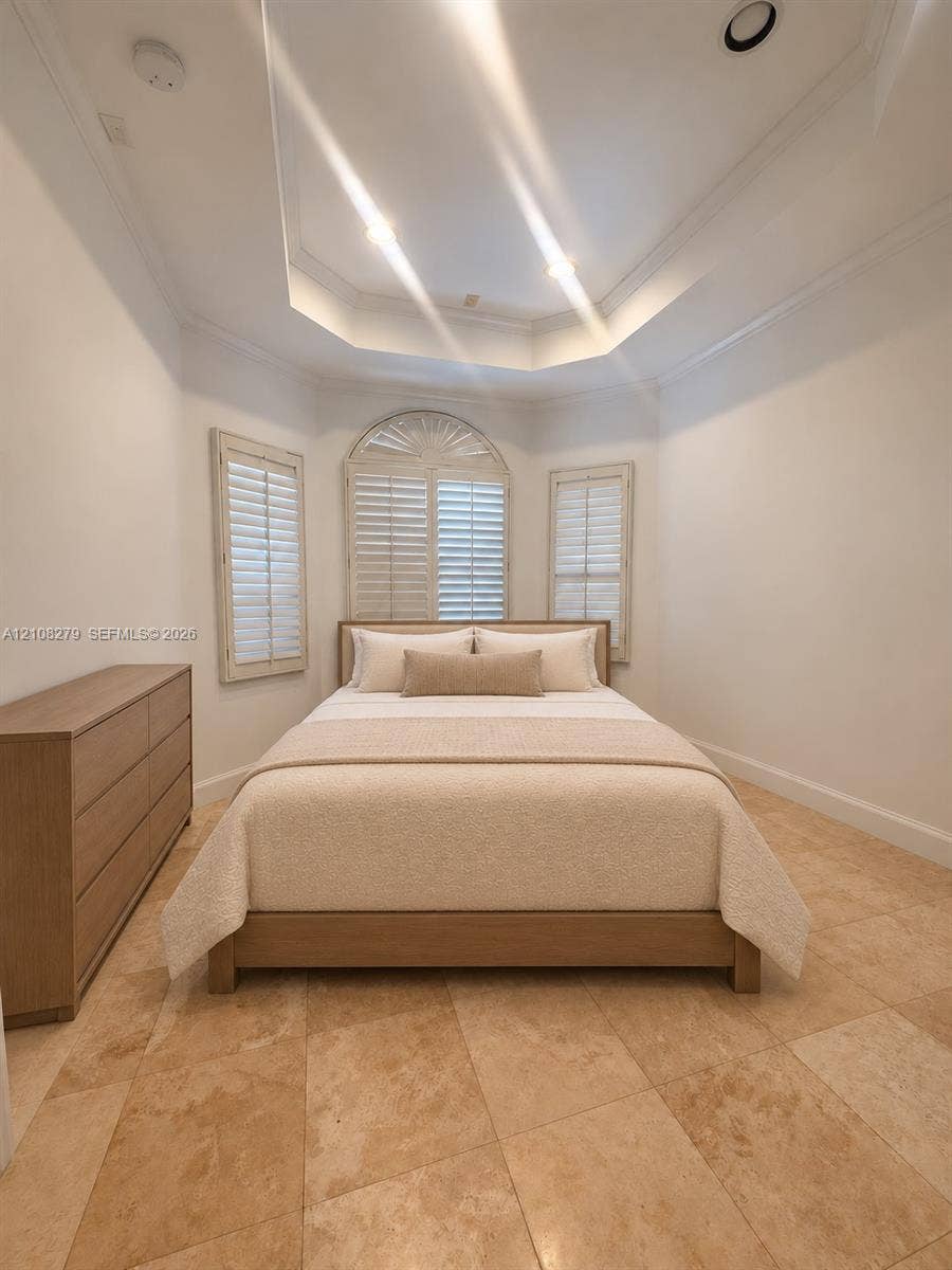 19424 39th Avenue, Sunny Isles Beach, Sunny Isles Beach, FL 33160 Tray ceiling featuring recessed lighting, stone tile flooring, and arched window with built-in interior shutters