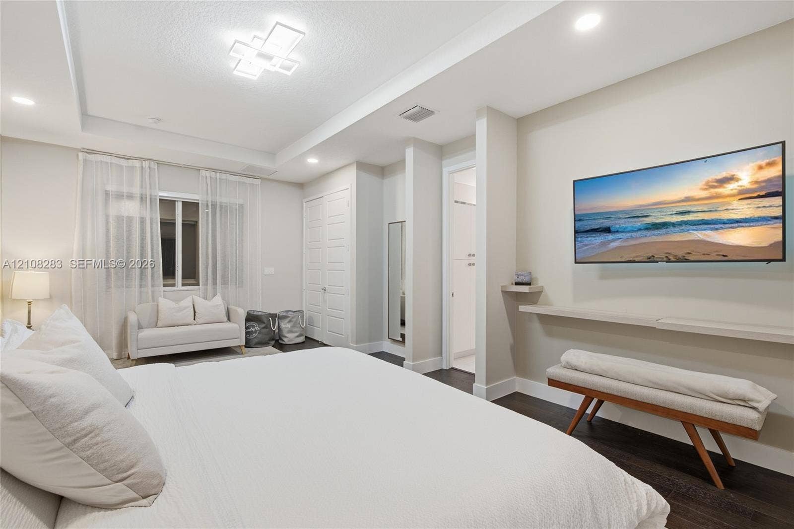 15215 SW 176th Lane, Miami, FL 33187 Tray ceiling with geometric flush-mount lighting, dark wood-finish flooring, recessed lighting, and a wall-mounted floating shelf