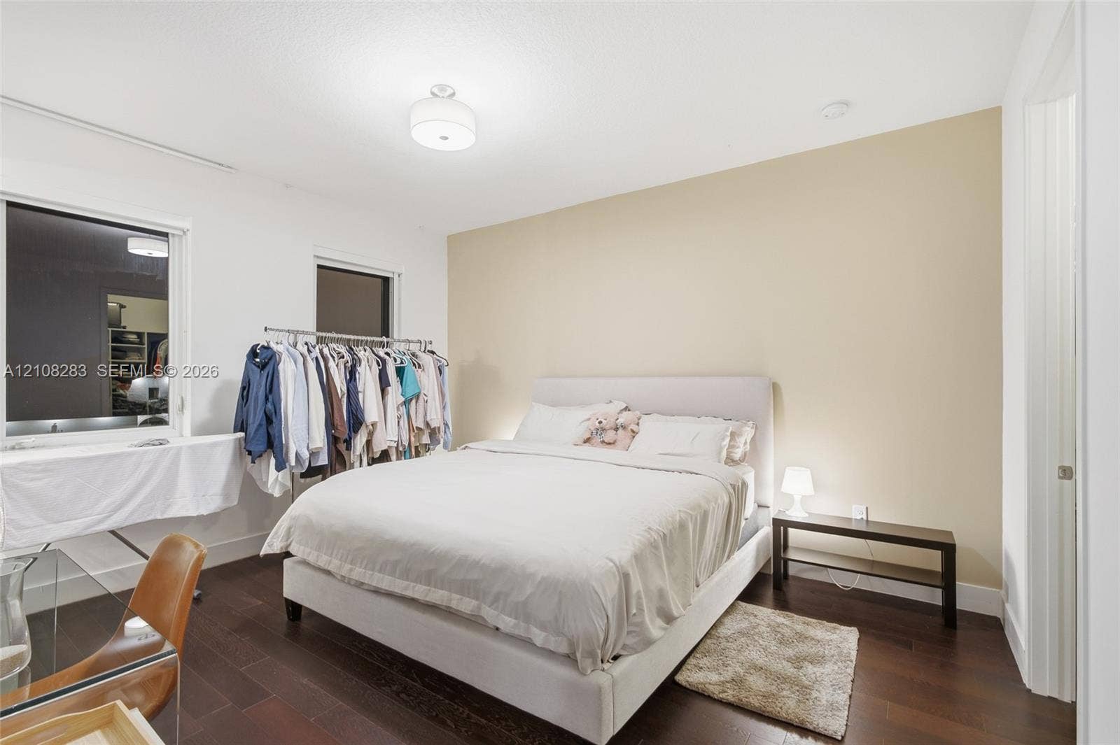 15215 SW 176th Lane, Miami, FL 33187 Bedroom featuring wood-finish flooring, two windows, a neutral accent wall, and a central ceiling-mounted light fixture