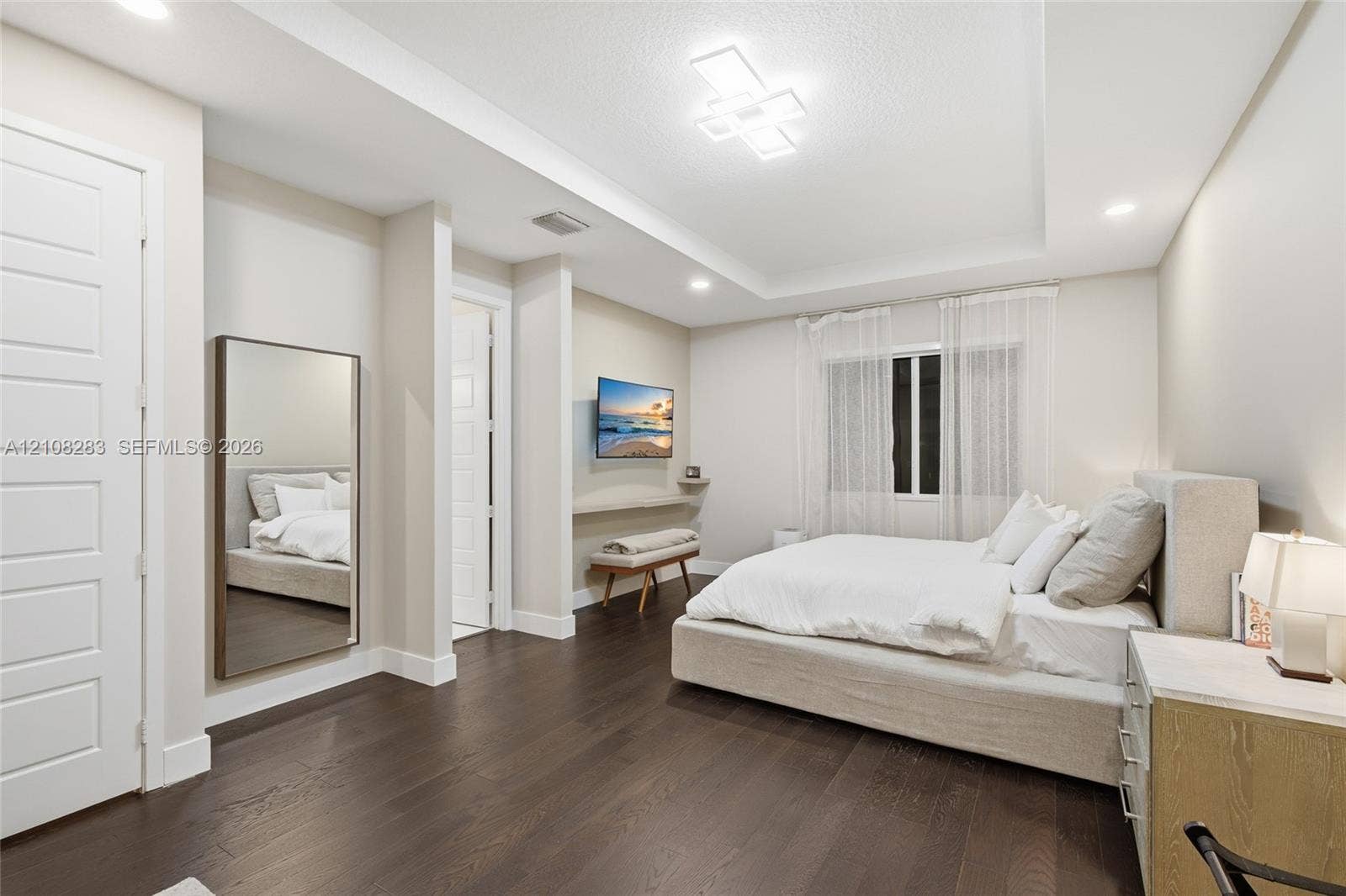 15215 SW 176th Lane, Miami, FL 33187 Bedroom featuring wood-finish flooring, tray ceiling with recessed and geometric modern lighting, and a wall-mounted floating display ledge