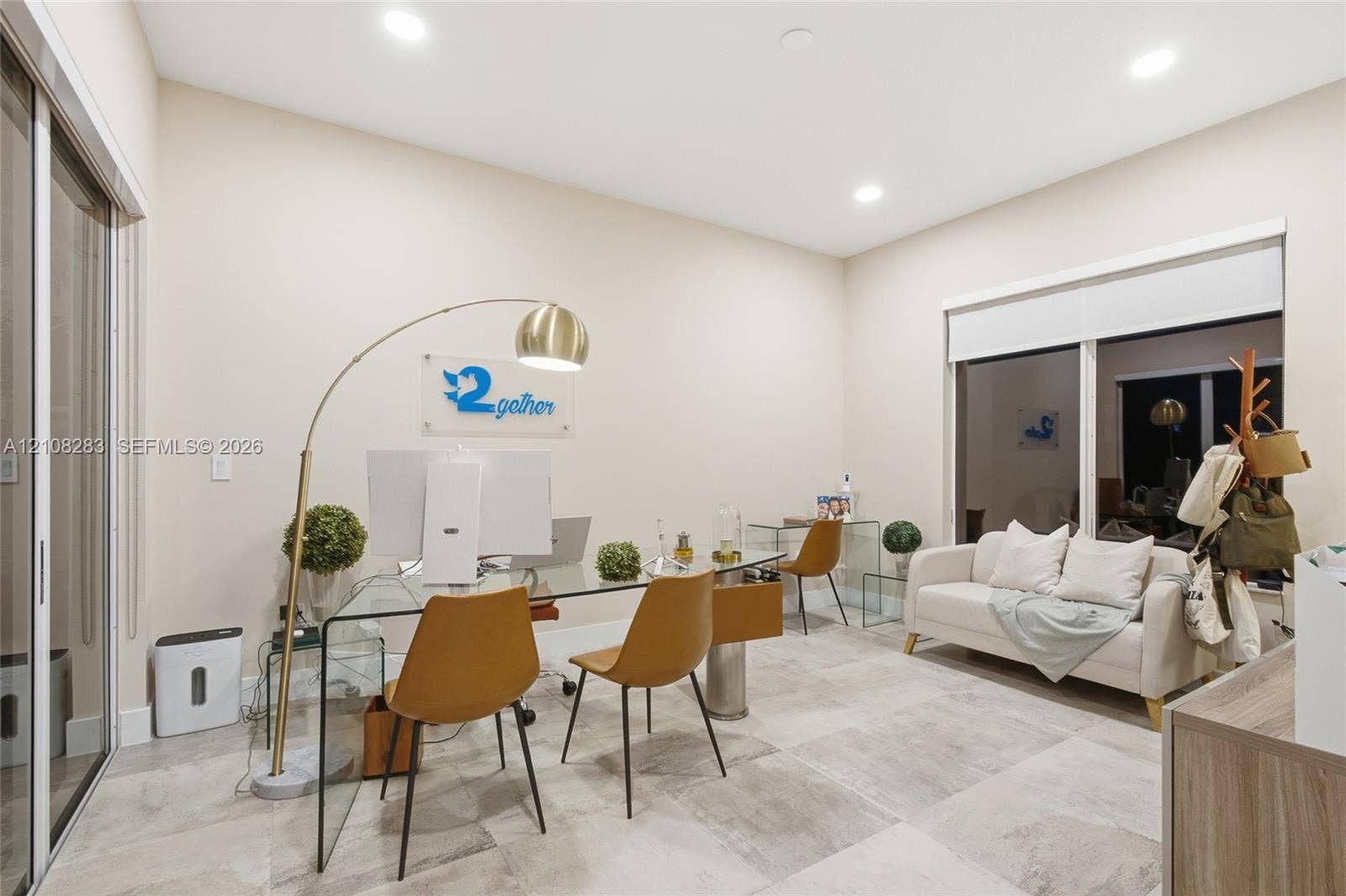 15215 SW 176th Lane, Miami, FL 33187 Neutral-toned room featuring large-format tile flooring, recessed ceiling lighting, and sliding glass doors with integrated roller shades