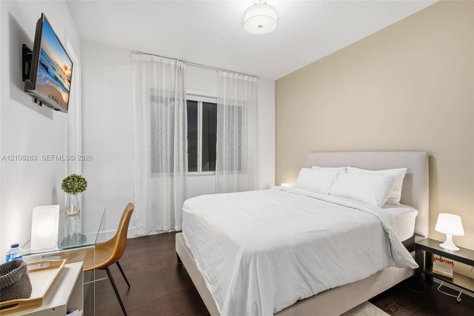 15215 SW 176th Lane, Miami, FL 33187 Room featuring dark wood-finish flooring, neutral-toned accent wall, and a central ceiling-mounted drum light fixture