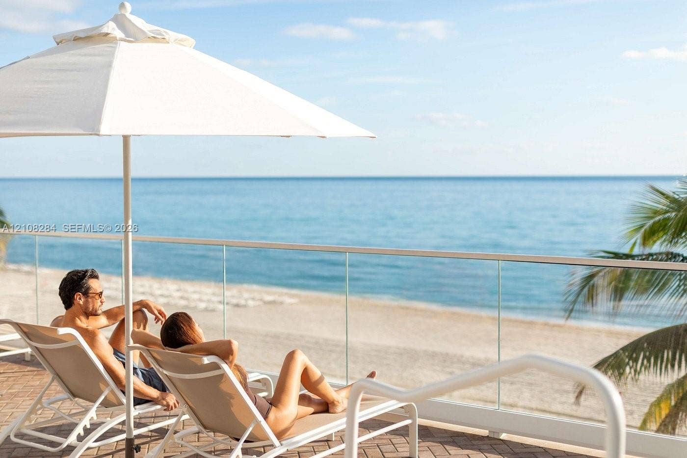 18001 Collins Avenue, #908, Sunny Isles Beach, FL 33160 Elevated terrace featuring a herringbone-patterned tile floor and a frameless glass railing overlooking the ocean