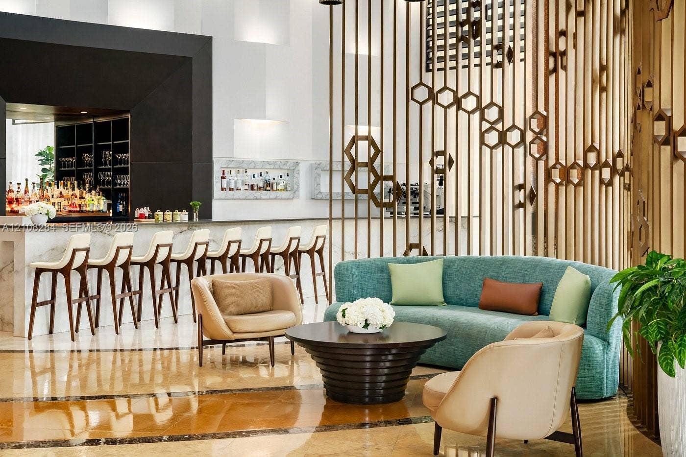 18001 Collins Avenue, #908, Sunny Isles Beach, FL 33160 Bar area featuring a stone-surface counter, geometric metal room partition, recessed wall shelving, and polished stone-finish flooring