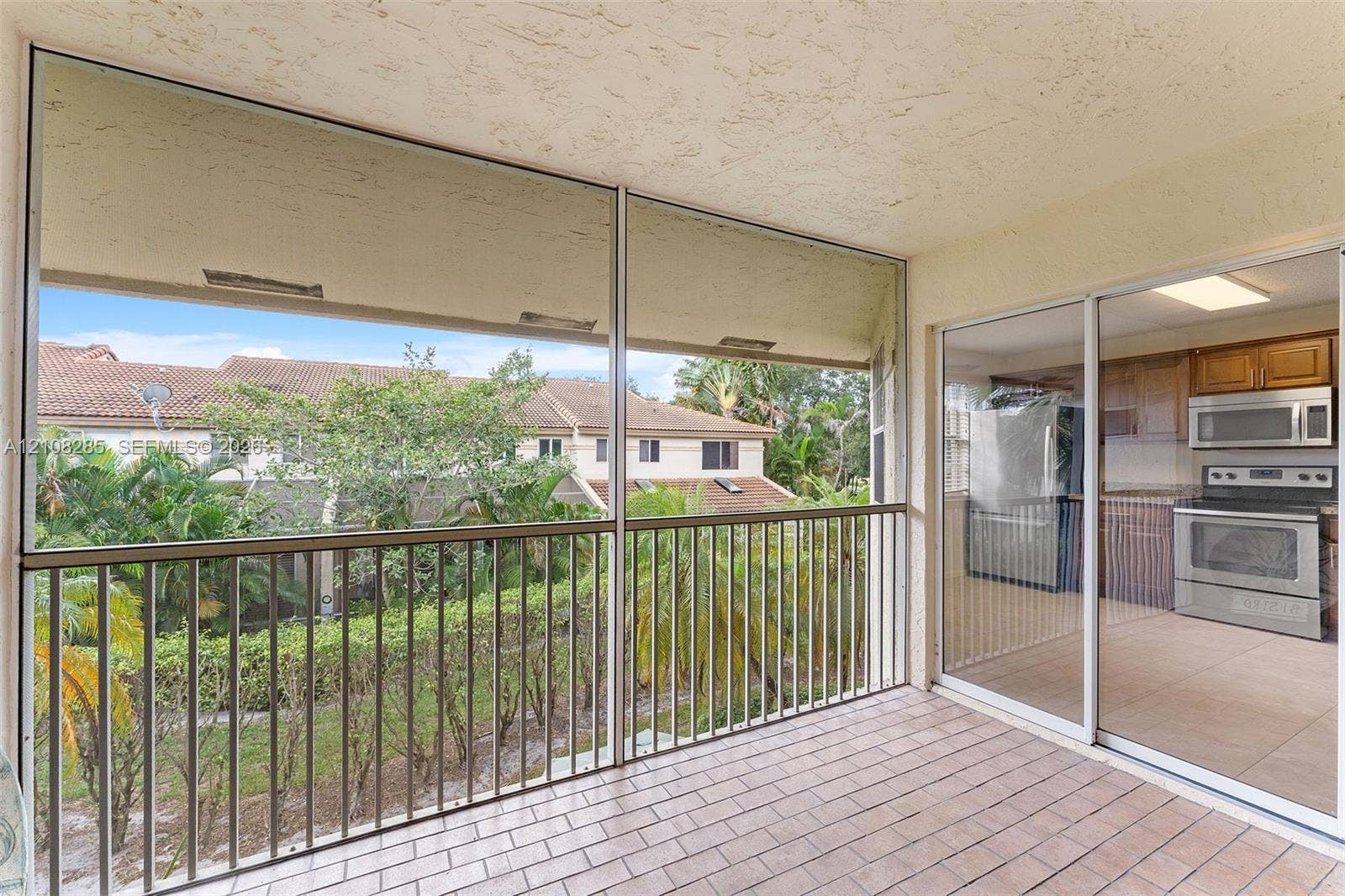 6626 Via Regina, #0, Boca Raton, Boca Raton, FL 33433 Screened-in balcony featuring tile flooring, metal railings, and sliding glass entry doors