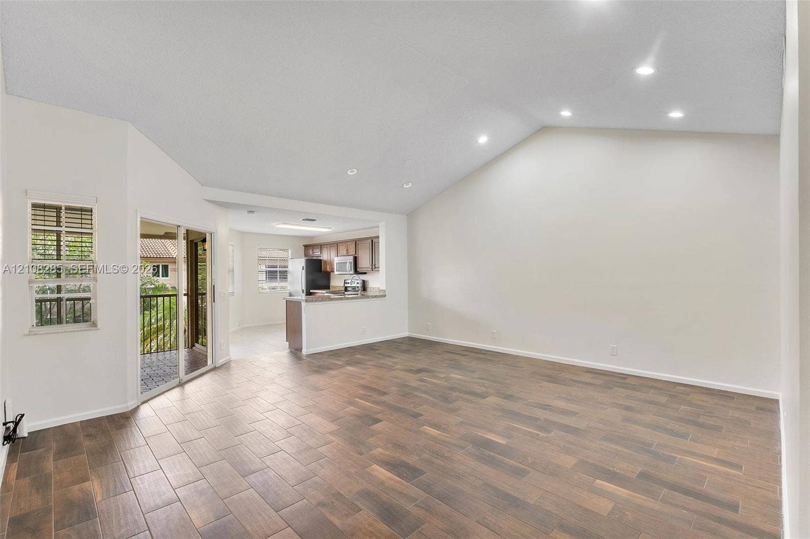 6626 Via Regina, #0, Boca Raton, Boca Raton, FL 33433 Vaulted ceilings with recessed lighting, wood-finish tile flooring, and glass sliding doors