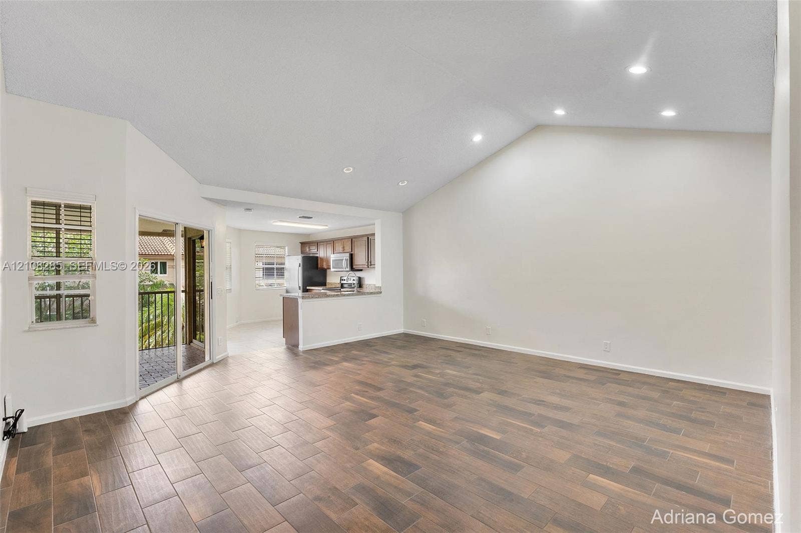 6626 Via Regina, #0, Boca Raton, Boca Raton, FL 33433 Vaulted ceilings with recessed lighting, wood-finish tile flooring, and sliding glass doors