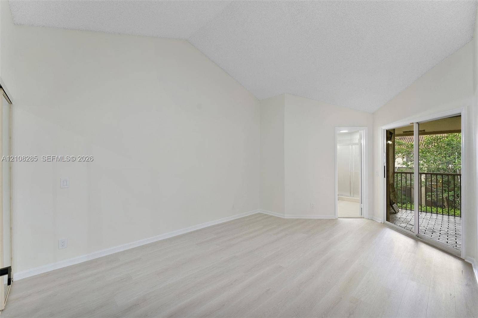 6626 Via Regina, #0, Boca Raton, Boca Raton, FL 33433 Vaulted ceilings, wood-finish flooring, and sliding glass doors with exterior balcony access