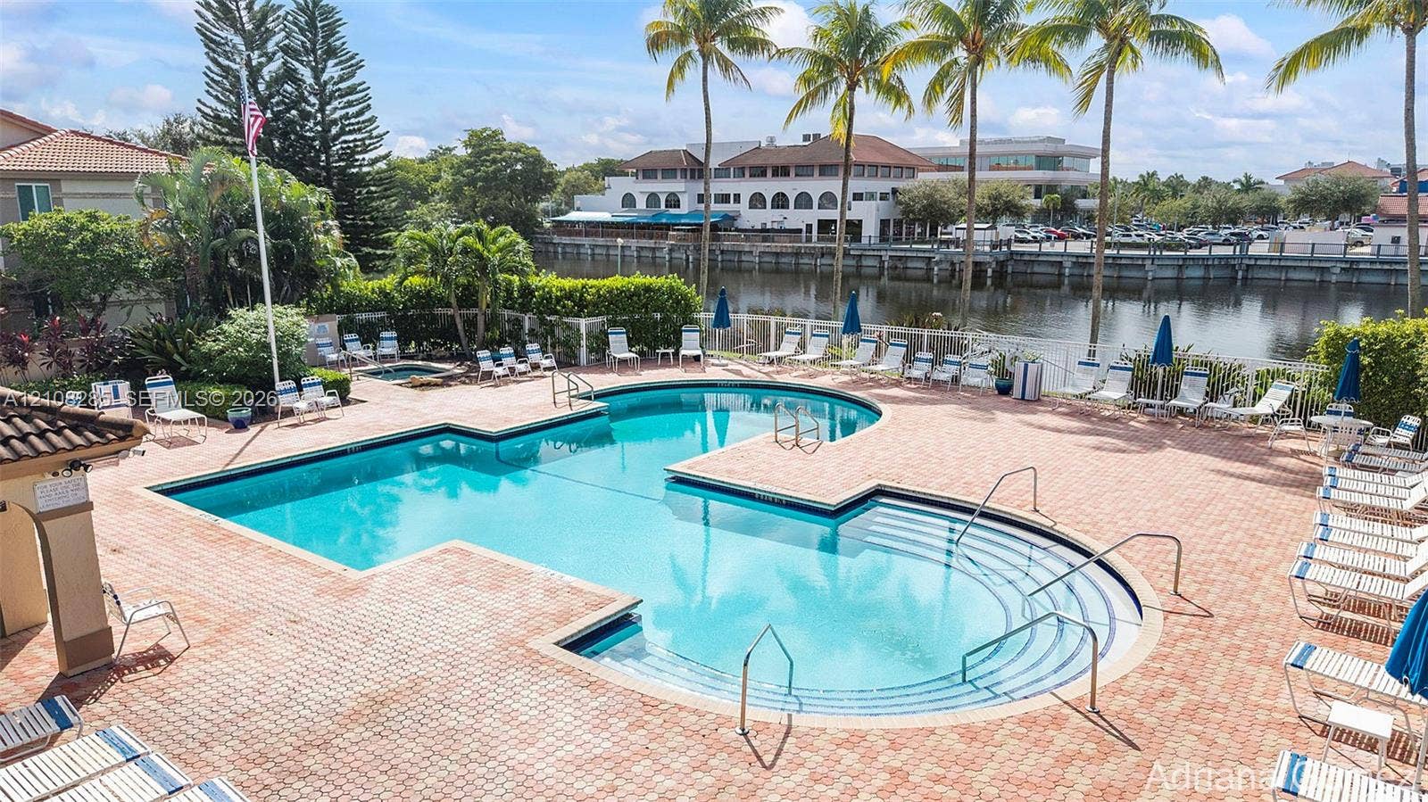 6626 Via Regina, #0, Boca Raton, Boca Raton, FL 33433 Swimming pool with integrated spa and stepped entry, surrounded by a brick paver deck and mature palm trees