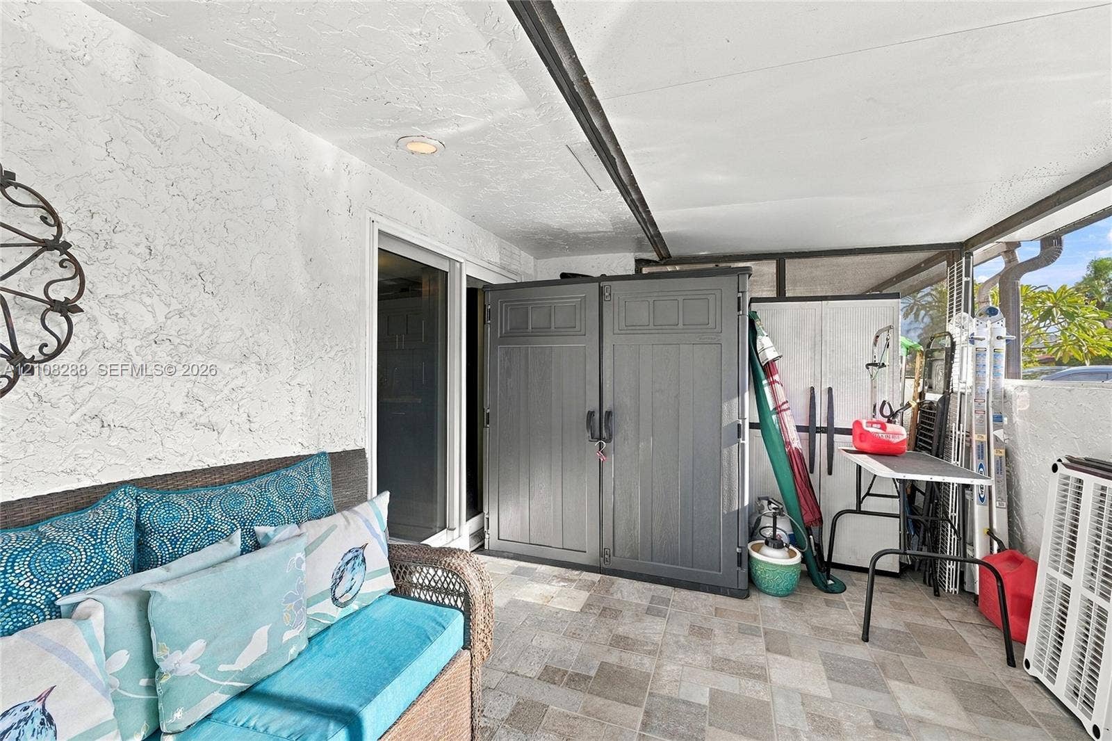 8292 NW 36th Street, Sunrise, FL 33351 Covered patio featuring textured walls, recessed lighting, and stone-finish tile flooring