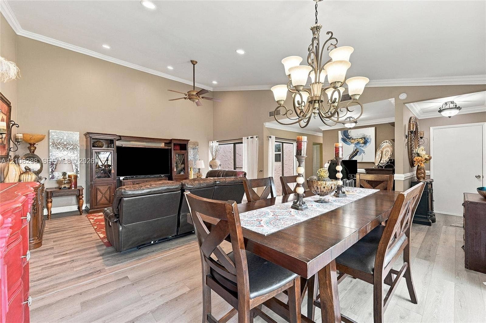 8292 NW 36th Street, Sunrise, FL 33351 Vaulted ceilings with recessed lighting, wood-finish flooring, and an ornate multi-arm chandelier
