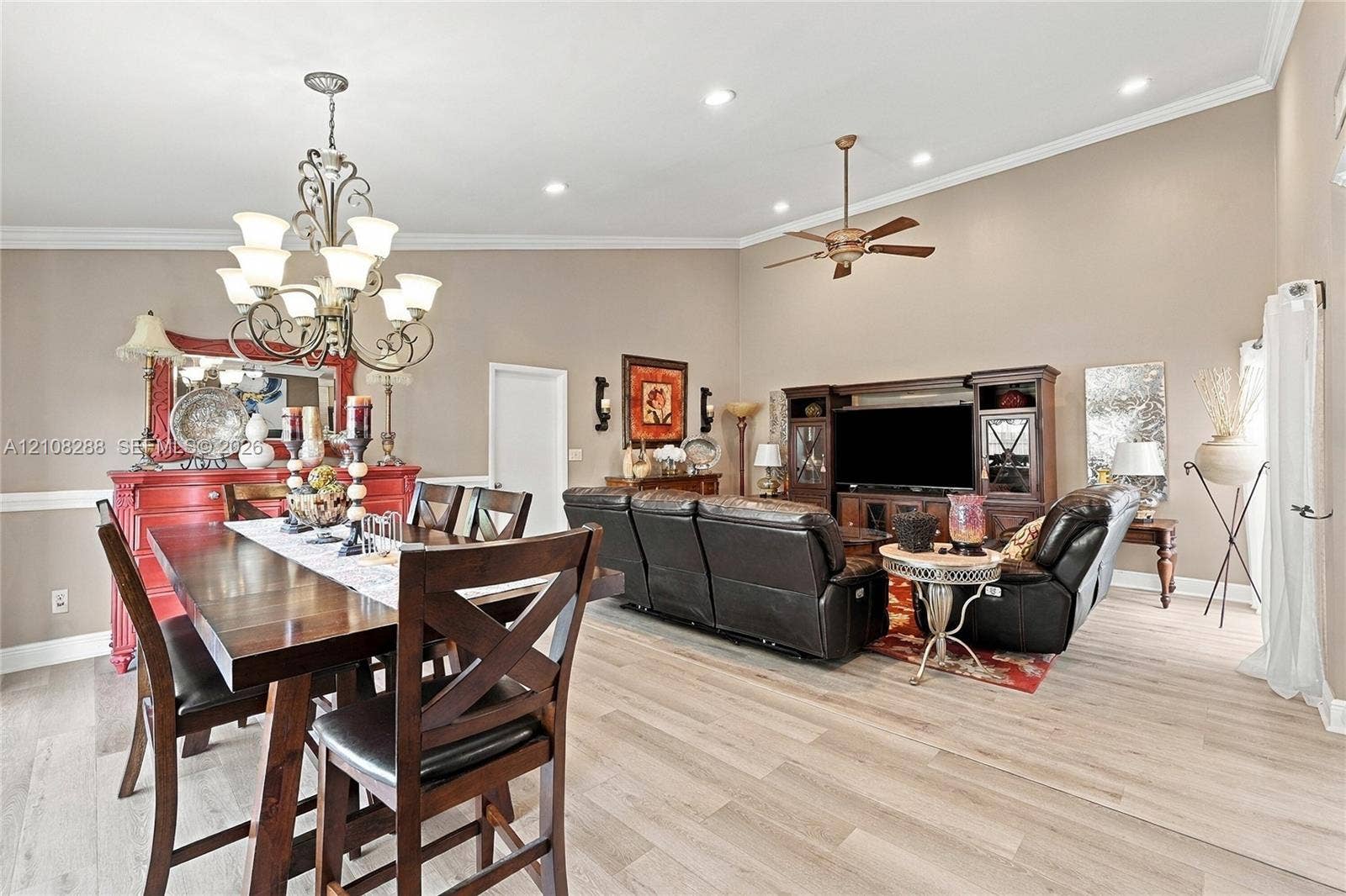 8292 NW 36th Street, Sunrise, FL 33351 Vaulted ceilings with recessed lighting, wood-finish flooring, crown molding, and an ornate wrought-iron chandelier