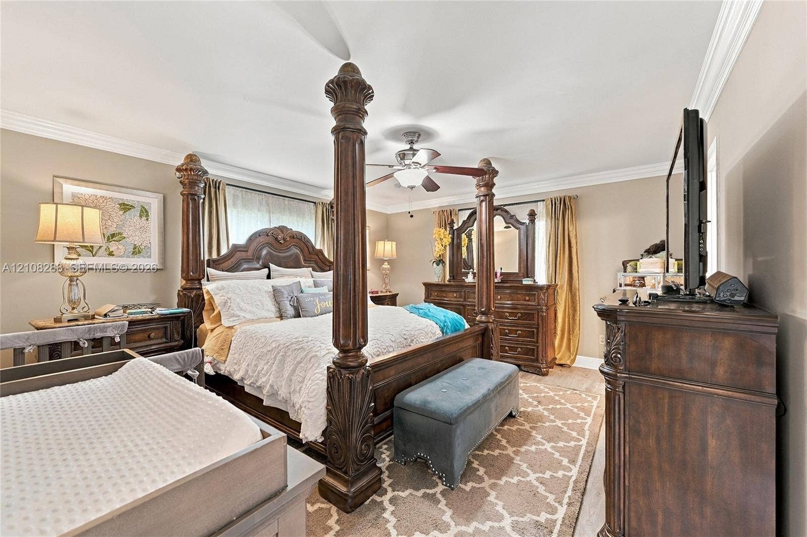 8292 NW 36th Street, Sunrise, FL 33351 Bedroom featuring crown molding, neutral wall tones, and a ceiling fan with integrated lighting