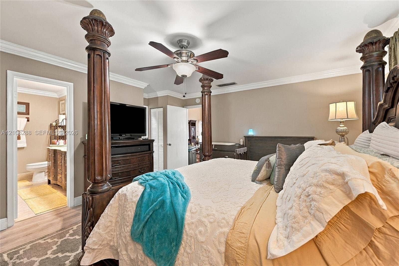 8292 NW 36th Street, Sunrise, FL 33351 Neutral-toned walls featuring crown molding, wood-finish flooring, and a ceiling fan with integrated lighting