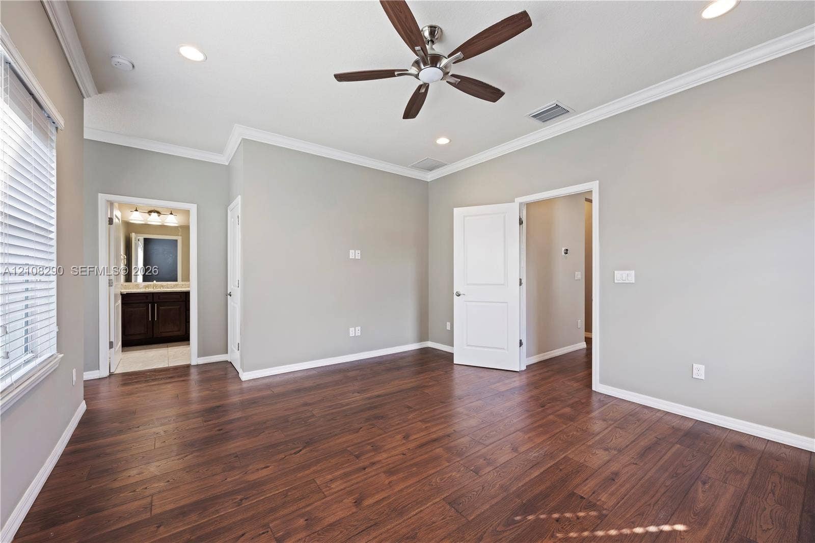 Room featuring wood-finish flooring, crown molding, recessed lighting, and a ceiling fan