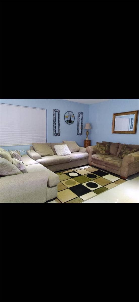 3556 N 10th Avenue N, Palm Springs, FL 33461 Room featuring light blue wall paint and large-format tile flooring