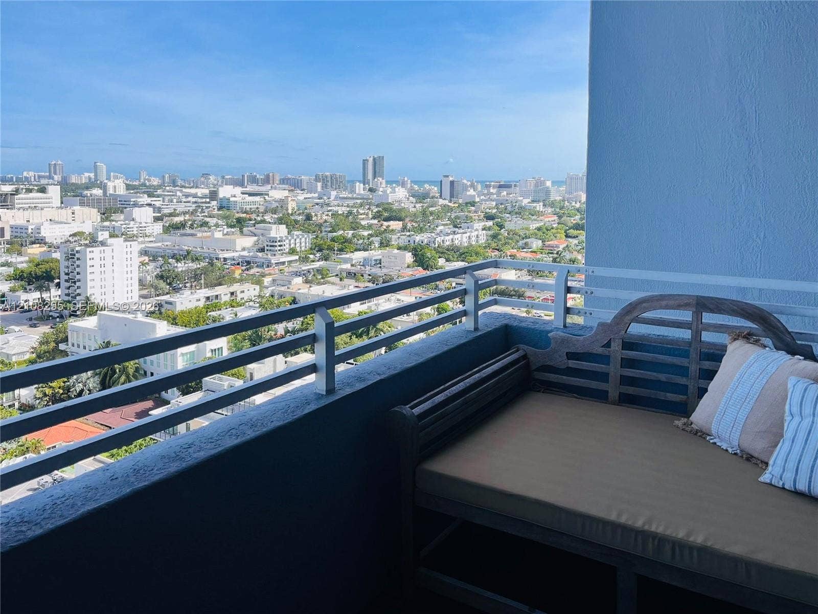Private balcony with a metal railing and expansive cityscape panorama