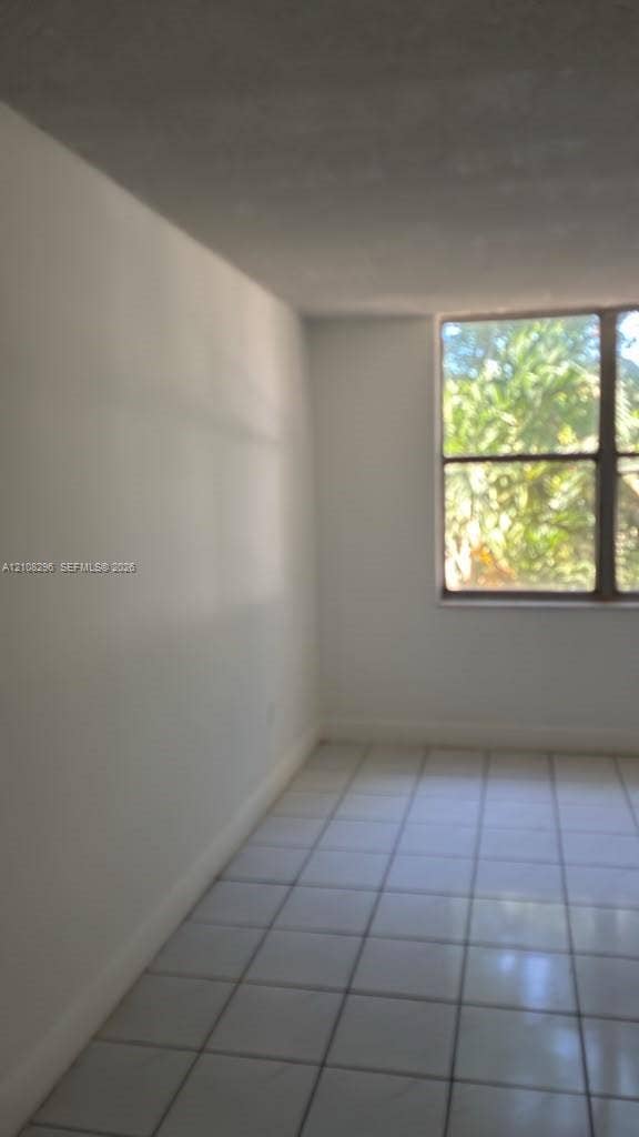 1800 Sans Souci Boulevard, #340, North Miami, North Miami, FL 33181 Interior space featuring large-format tile flooring and a multi-pane window