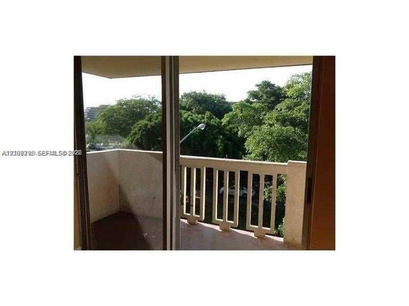 1800 Sans Souci Boulevard, #340, North Miami, North Miami, FL 33181 Private balcony featuring a concrete floor, solid masonry wall enclosure, and structural balustrade railing