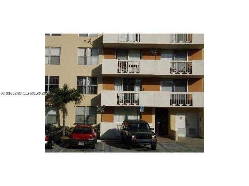 1800 Sans Souci Boulevard, #340, North Miami, North Miami, FL 33181 Multi-story exterior facade featuring concrete balconies with vertical railings, stucco finish, grid-pattern windows, and exterior parking