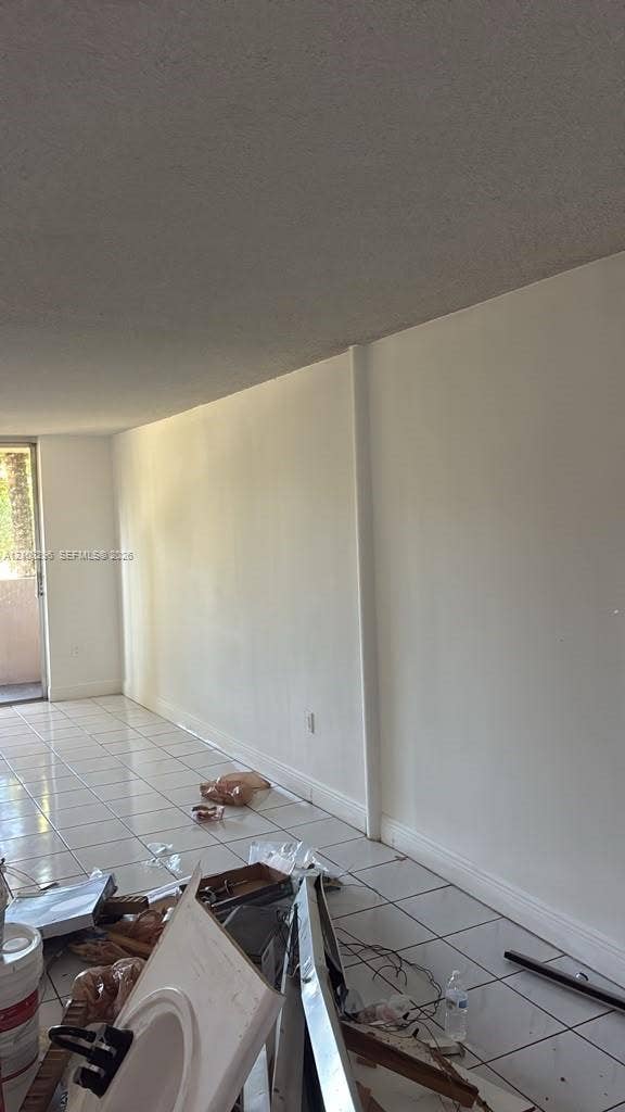 1800 Sans Souci Boulevard, #340, North Miami, North Miami, FL 33181 Interior space featuring white-toned tile flooring and an exterior glass door