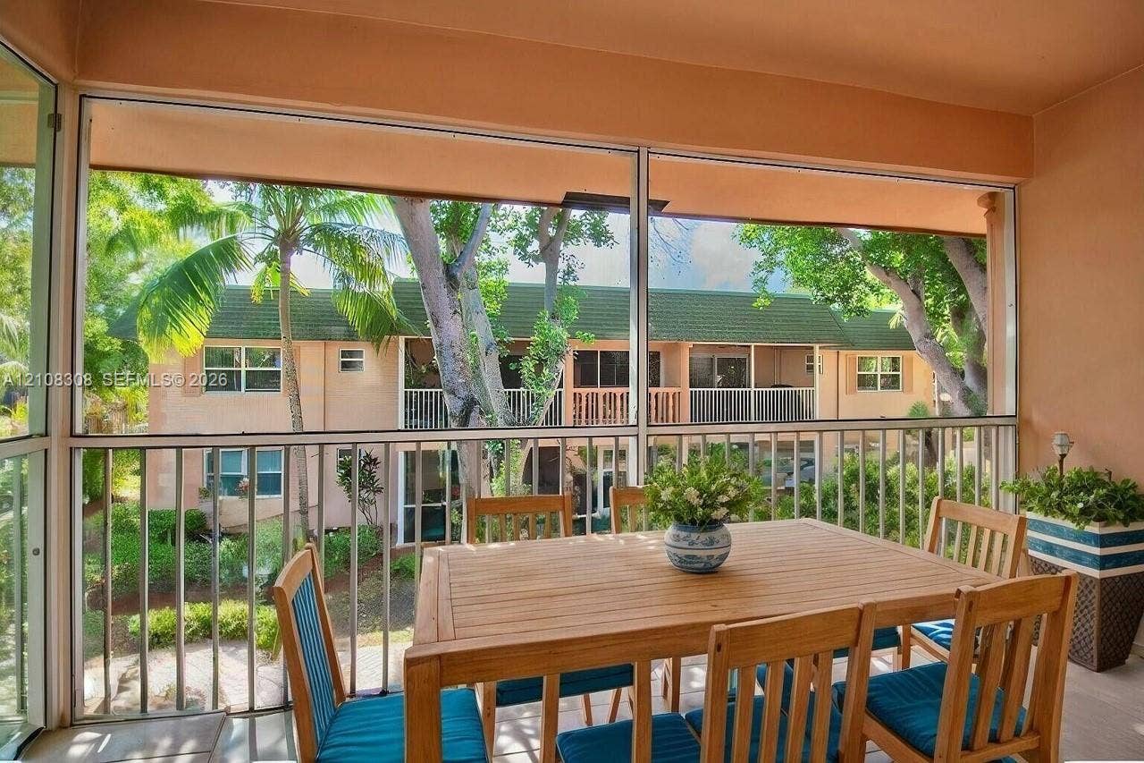 770 SE 2nd Avenue, #E201, Deerfield Beach, FL 33441 Screened lanai featuring an aluminum-framed enclosure and metal railings