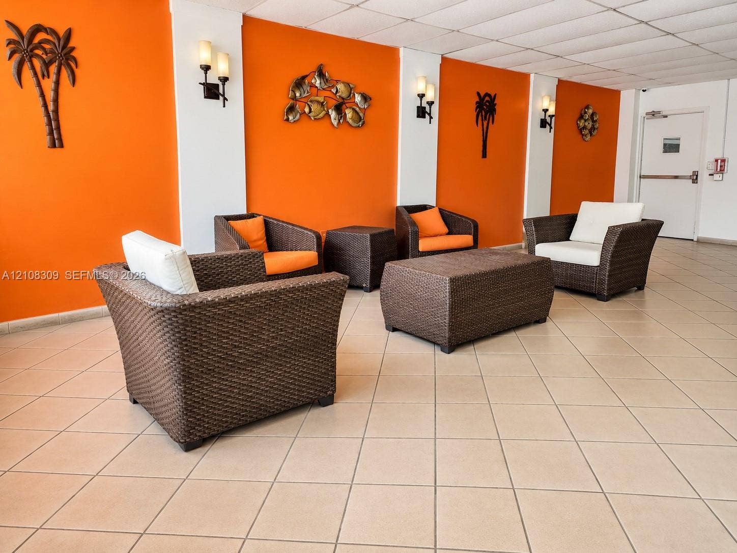 Common area featuring ceramic tile flooring, neutral wall accents, and wall-mounted light fixtures