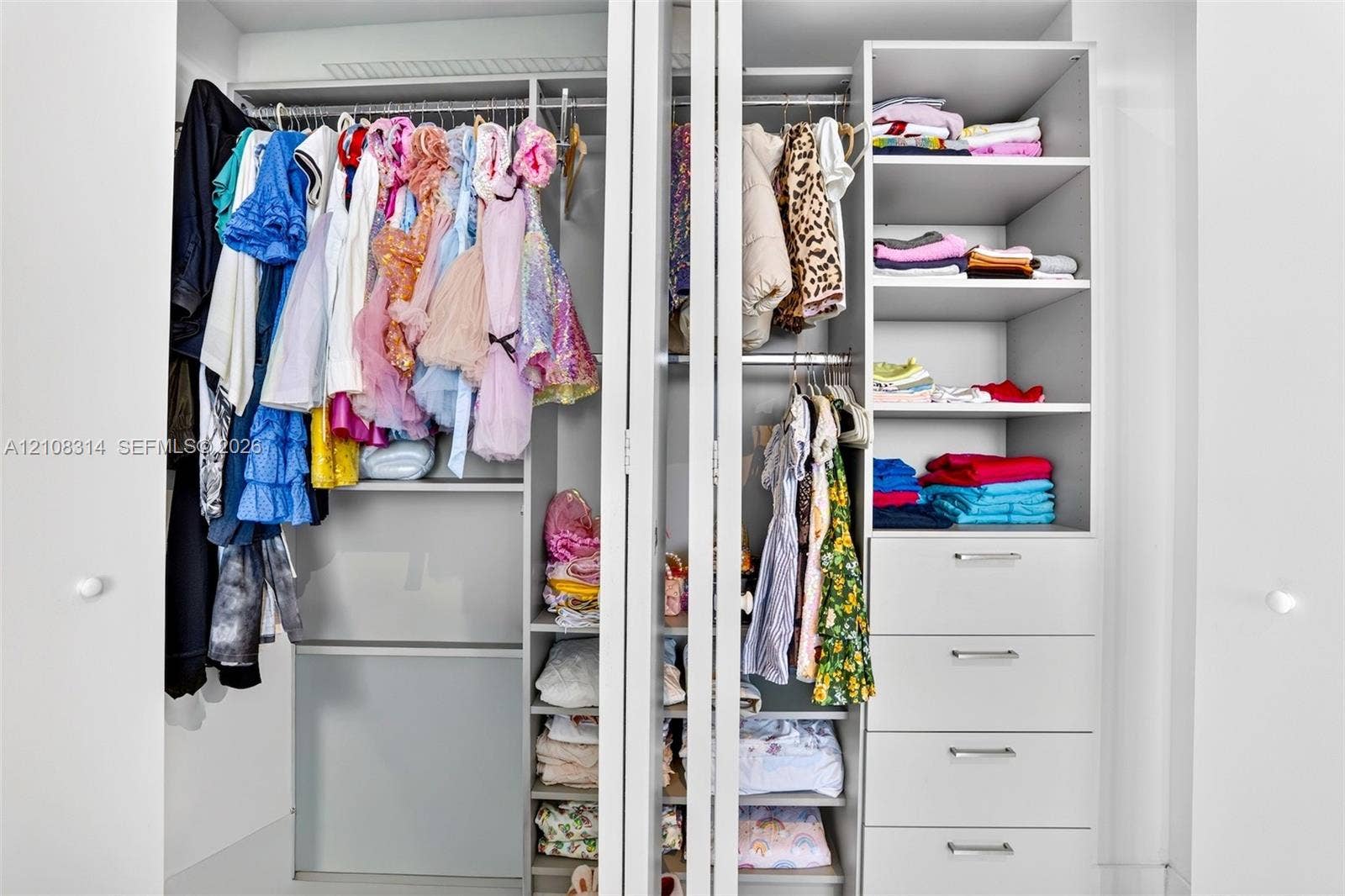 488 NE 18th Street, #4010, Miami, FL 33132 Built-in closet system featuring dual hanging rods, four integrated storage drawers, and multiple open-concept shelving units with a matte white finish