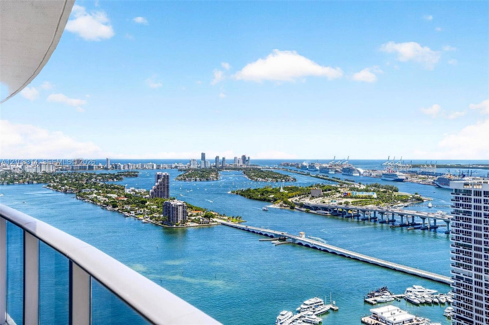 488 NE 18th Street, #4010, Miami, FL 33132 Elevated balcony featuring a glass panel railing and panoramic water-facing vistas of the coastline, islands, and metropolitan skyline