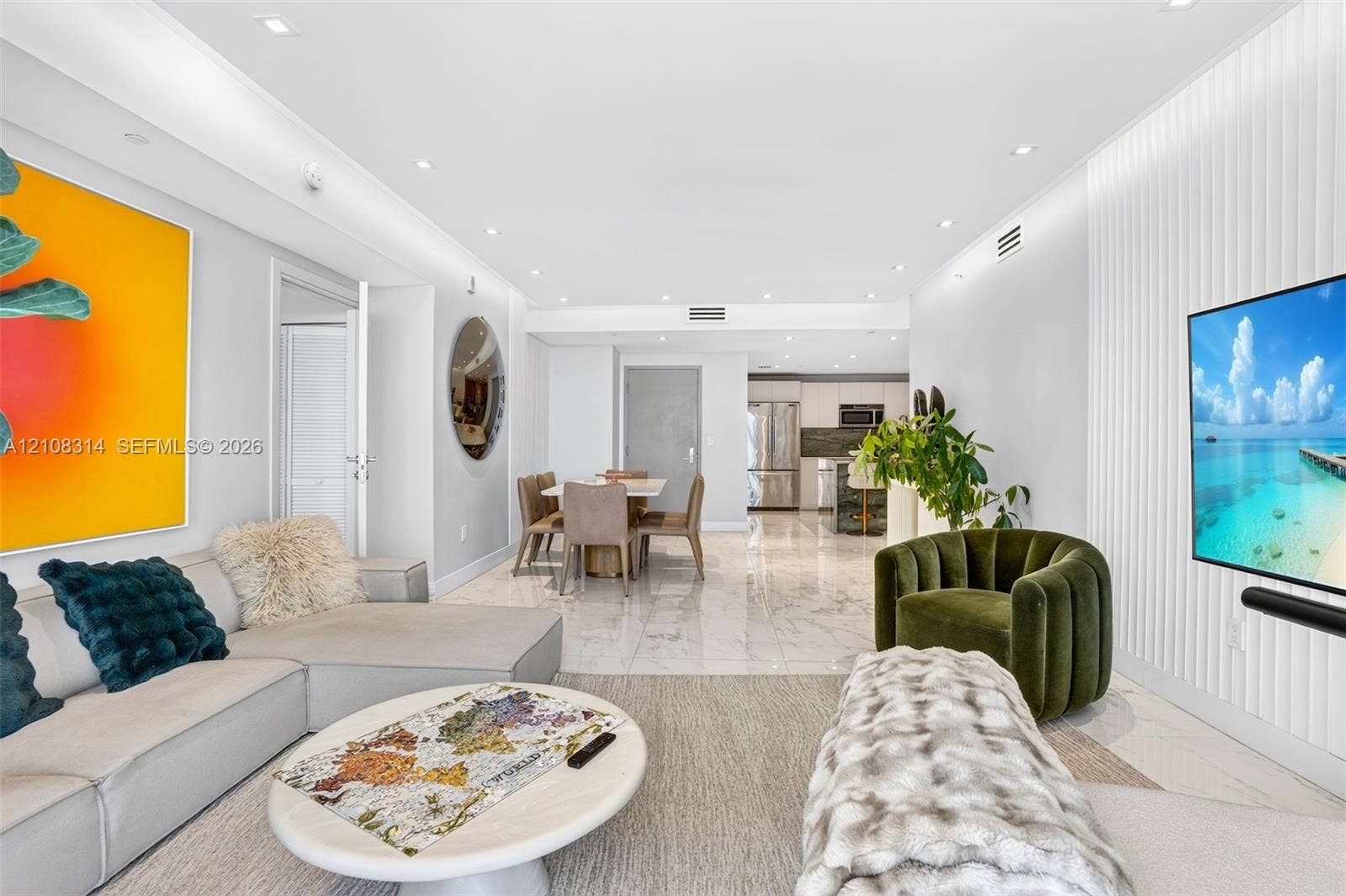 488 NE 18th Street, #4010, Miami, FL 33132 Open-concept living space featuring high-gloss large-format tile flooring, recessed ceiling lighting, and a floor-to-ceiling vertical slat accent wall