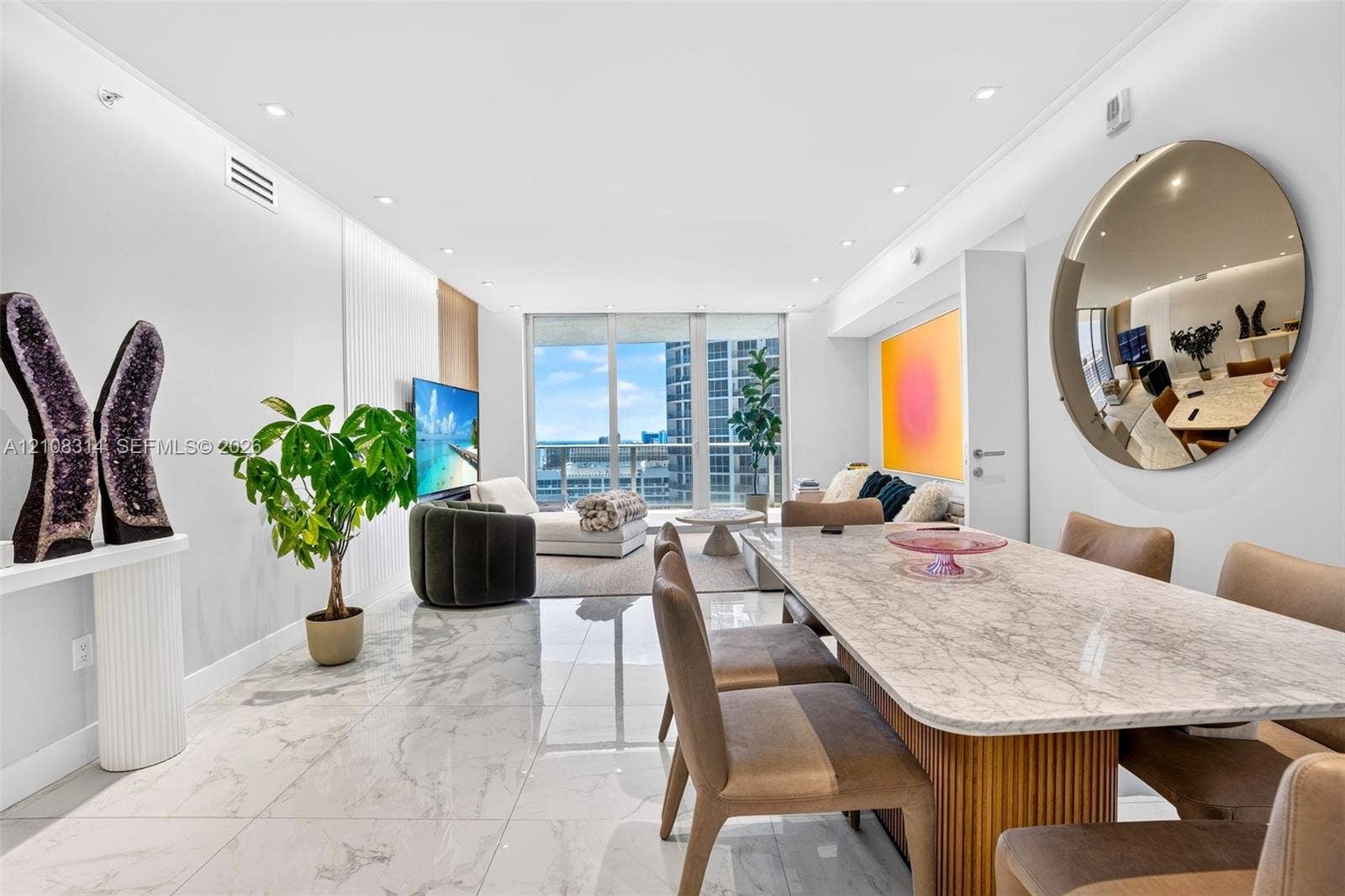 488 NE 18th Street, #4010, Miami, FL 33132 Open-concept living space featuring large-format polished stone flooring, recessed ceiling lighting, and floor-to-ceiling glass windows