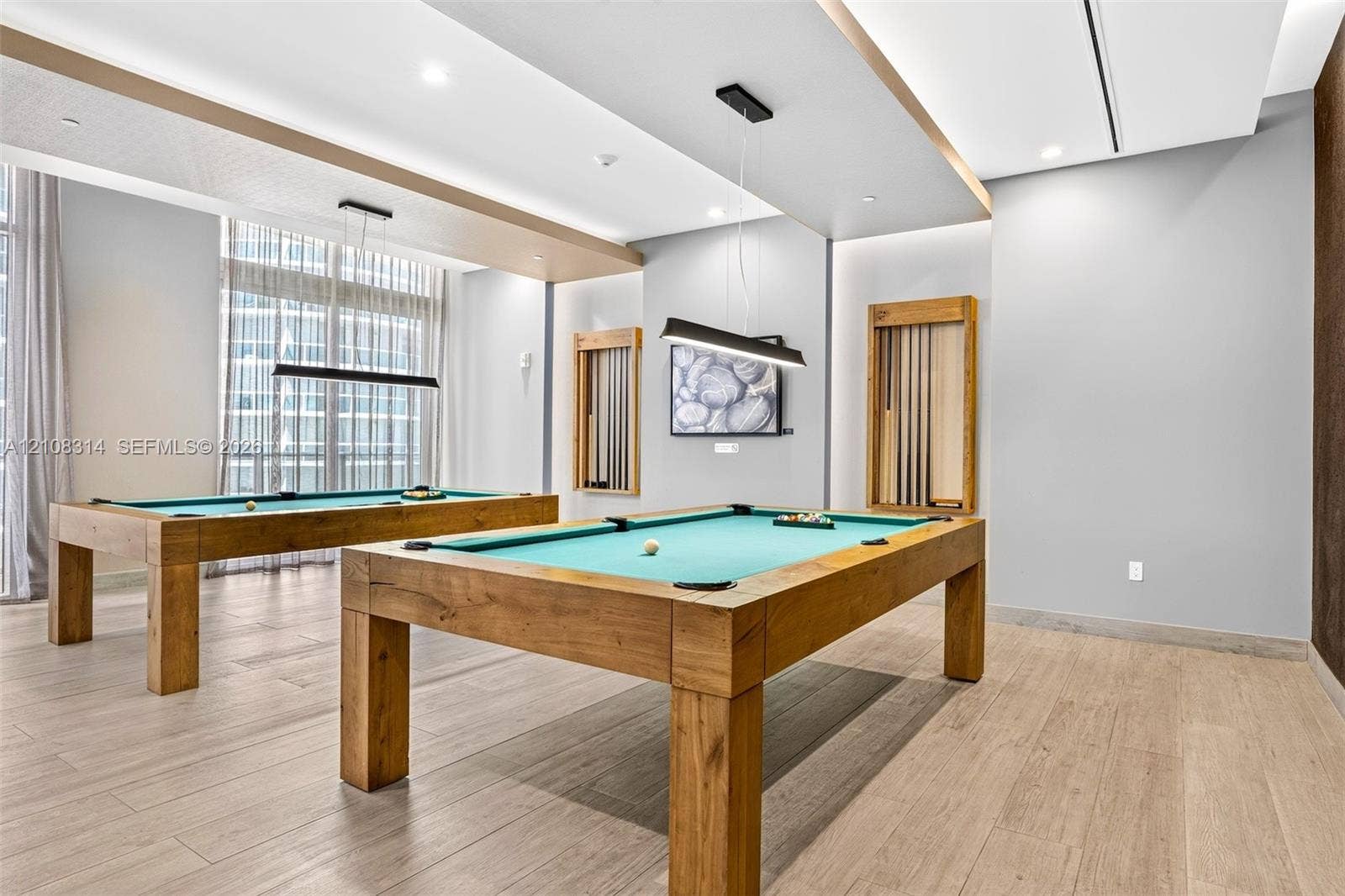 488 NE 18th Street, #4010, Miami, FL 33132 Recessed tray ceilings with integrated lighting, wood-finish flooring, and built-in wall-mounted cue racks