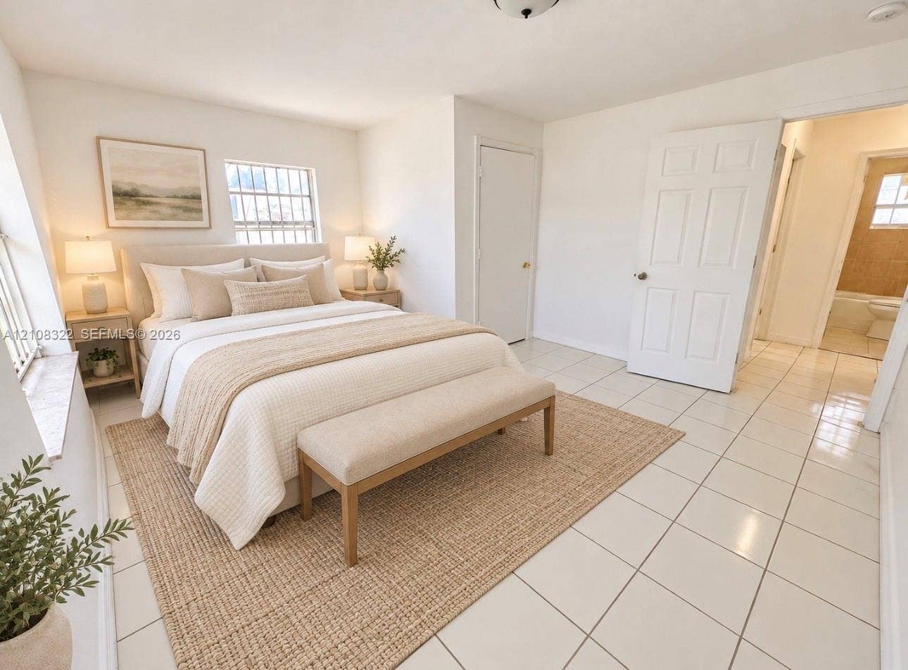 722 NW 7th Avenue, Homestead, FL 33030 Neutral-toned interior space featuring light-colored ceramic tile flooring, multiple windows providing natural light, and a six-panel interior door