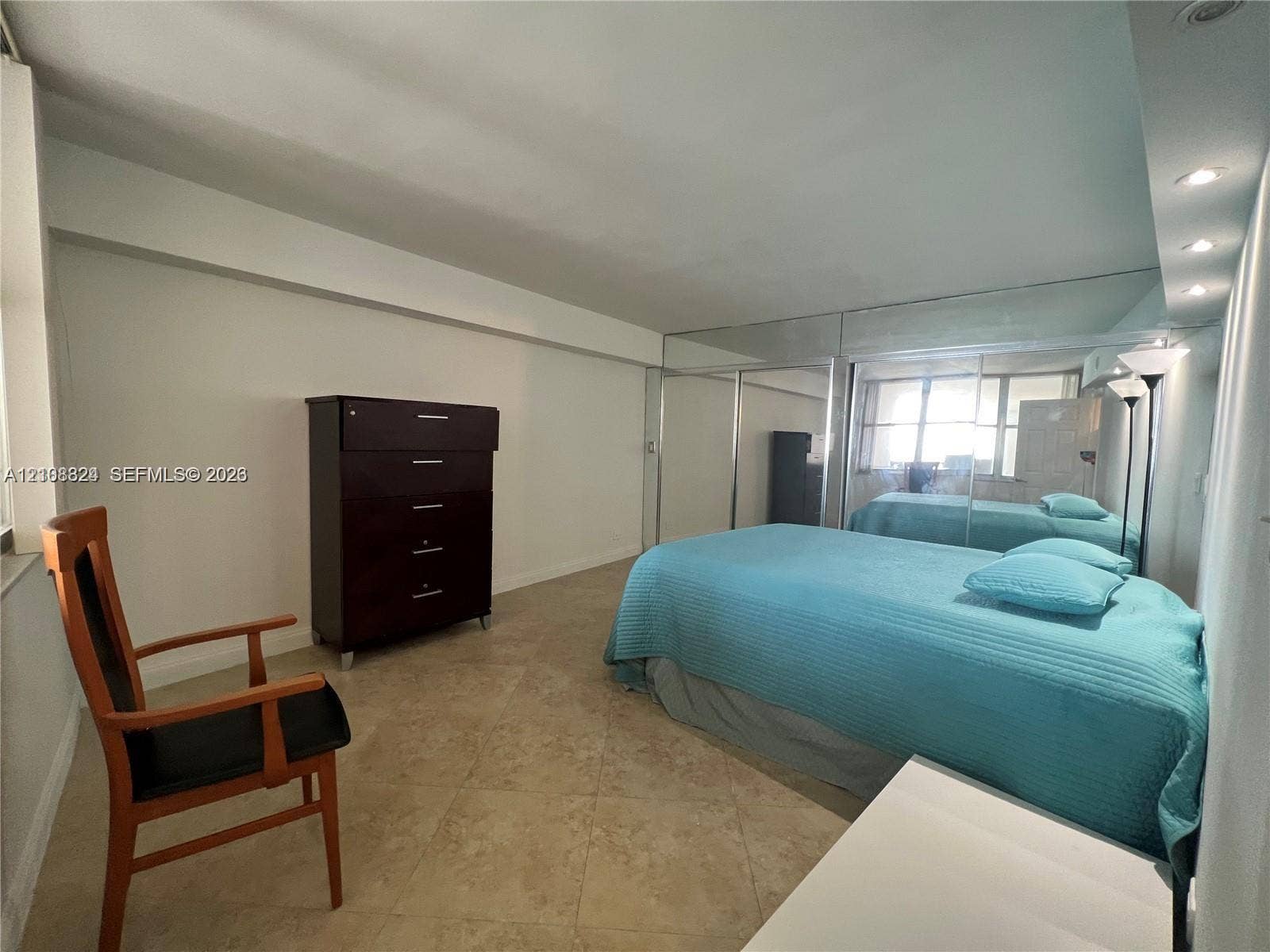 6039 Collins Avenue, #1208, Miami Beach, FL 33140 Tile flooring, floor-to-ceiling mirrored closet doors, and recessed ceiling lighting