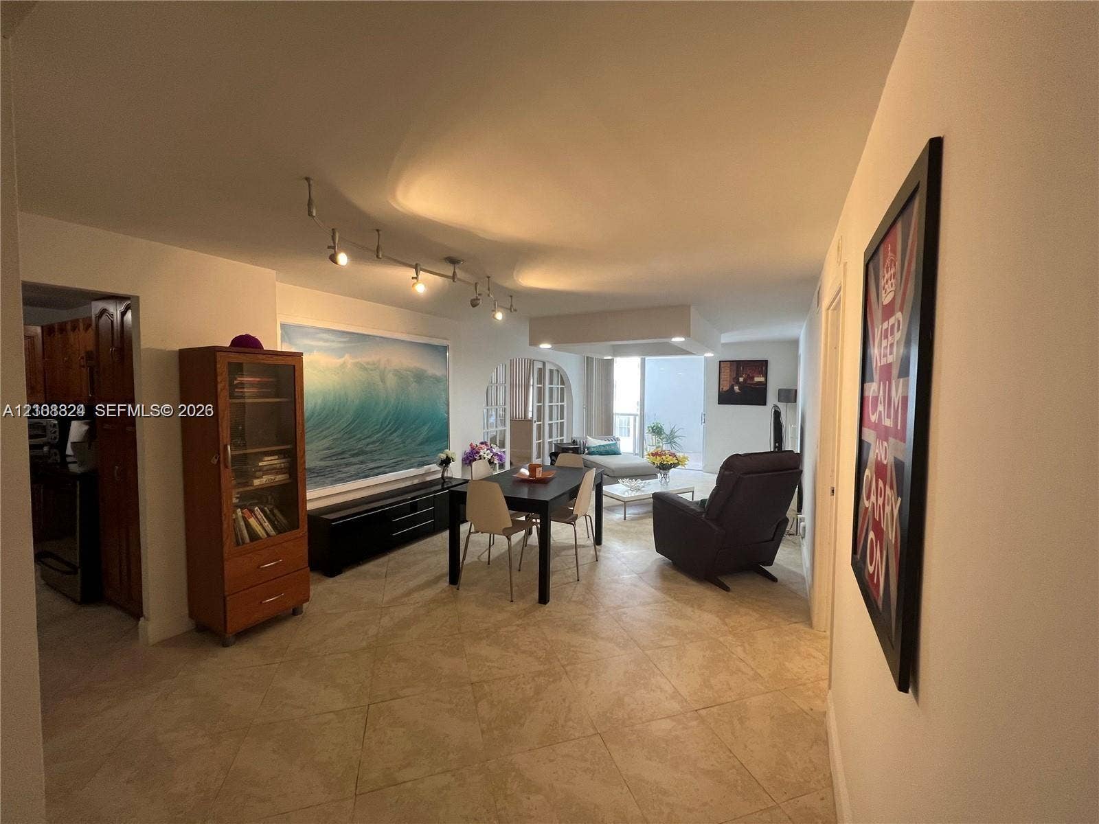 6039 Collins Avenue, #1208, Miami Beach, FL 33140 Large-format tile flooring, adjustable track lighting, and a distinct arched architectural doorway
