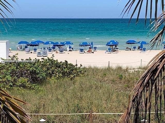 6039 Collins Avenue, #1208, Miami Beach, FL 33140 Coastal landscape featuring direct access to a sand beach, native vegetation, and oceanfront proximity