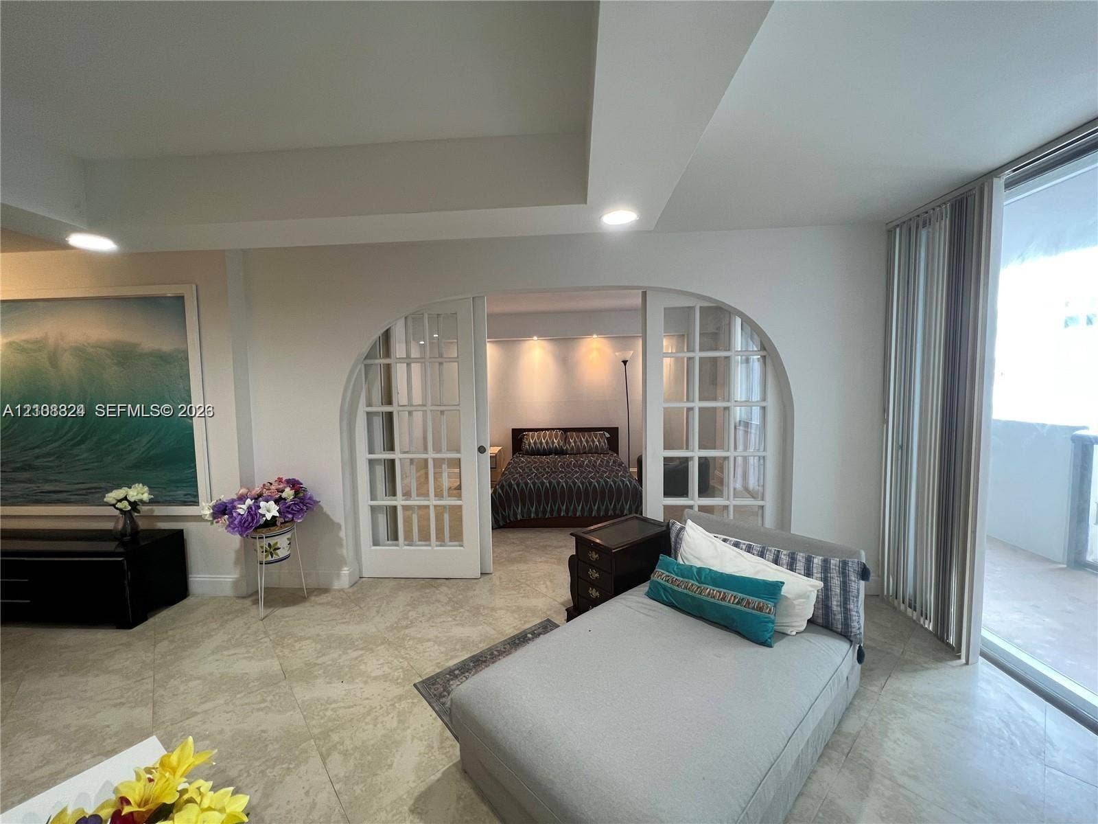 6039 Collins Avenue, #1208, Miami Beach, FL 33140 Interior space featuring large-format tile flooring, recessed ceiling lighting, and expansive sliding glass doors