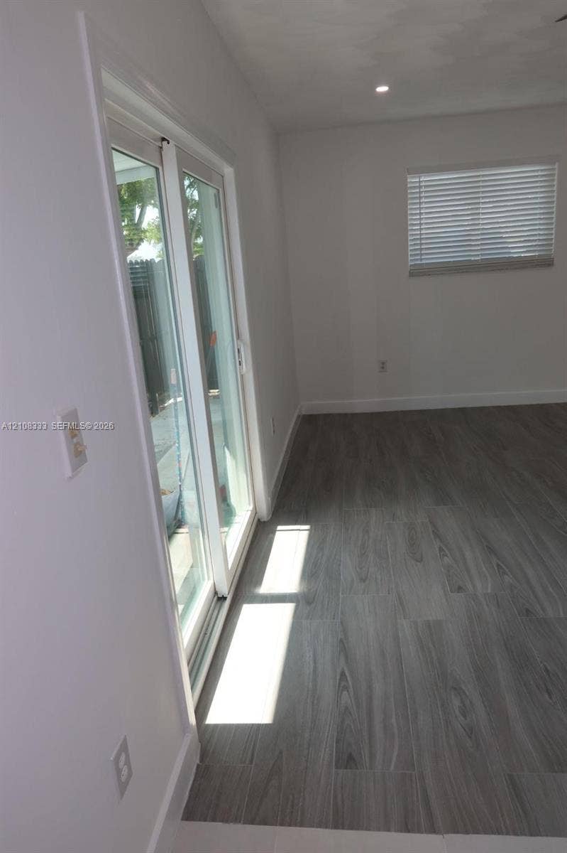 10450 SW 166th Terrace, #0, Miami, Miami, FL 33157 Wood-finish flooring, sliding glass door, recessed ceiling lighting, and horizontal window blinds