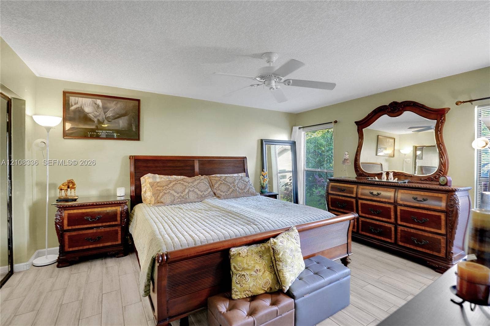 6311 Hitchin Post Way, Delray Beach, FL 33484 Wood-finish tile flooring, ceiling fan, and windows with natural light