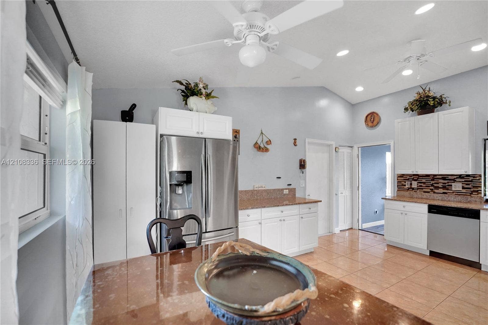 6311 Hitchin Post Way, Delray Beach, FL 33484 Kitchen featuring white cabinetry, stone-finish countertops, tile flooring, recessed lighting, and stainless steel appliances