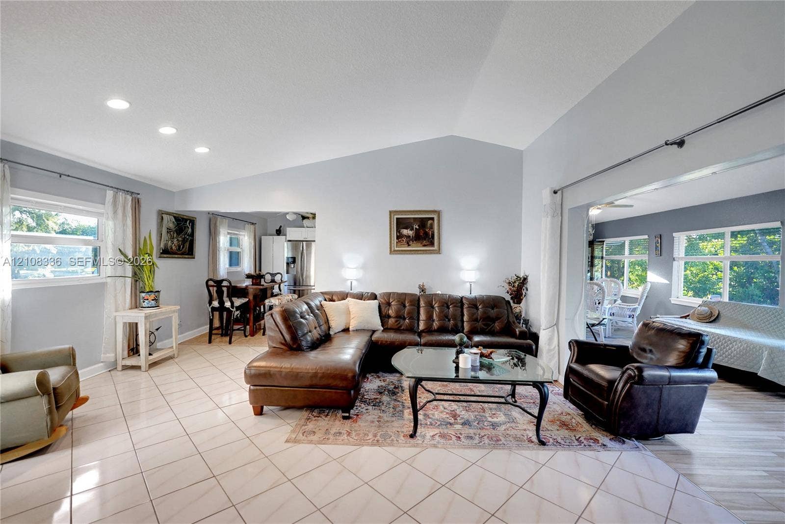 6311 Hitchin Post Way, Delray Beach, FL 33484 Living area featuring vaulted ceilings, recessed lighting, and ceramic tile flooring