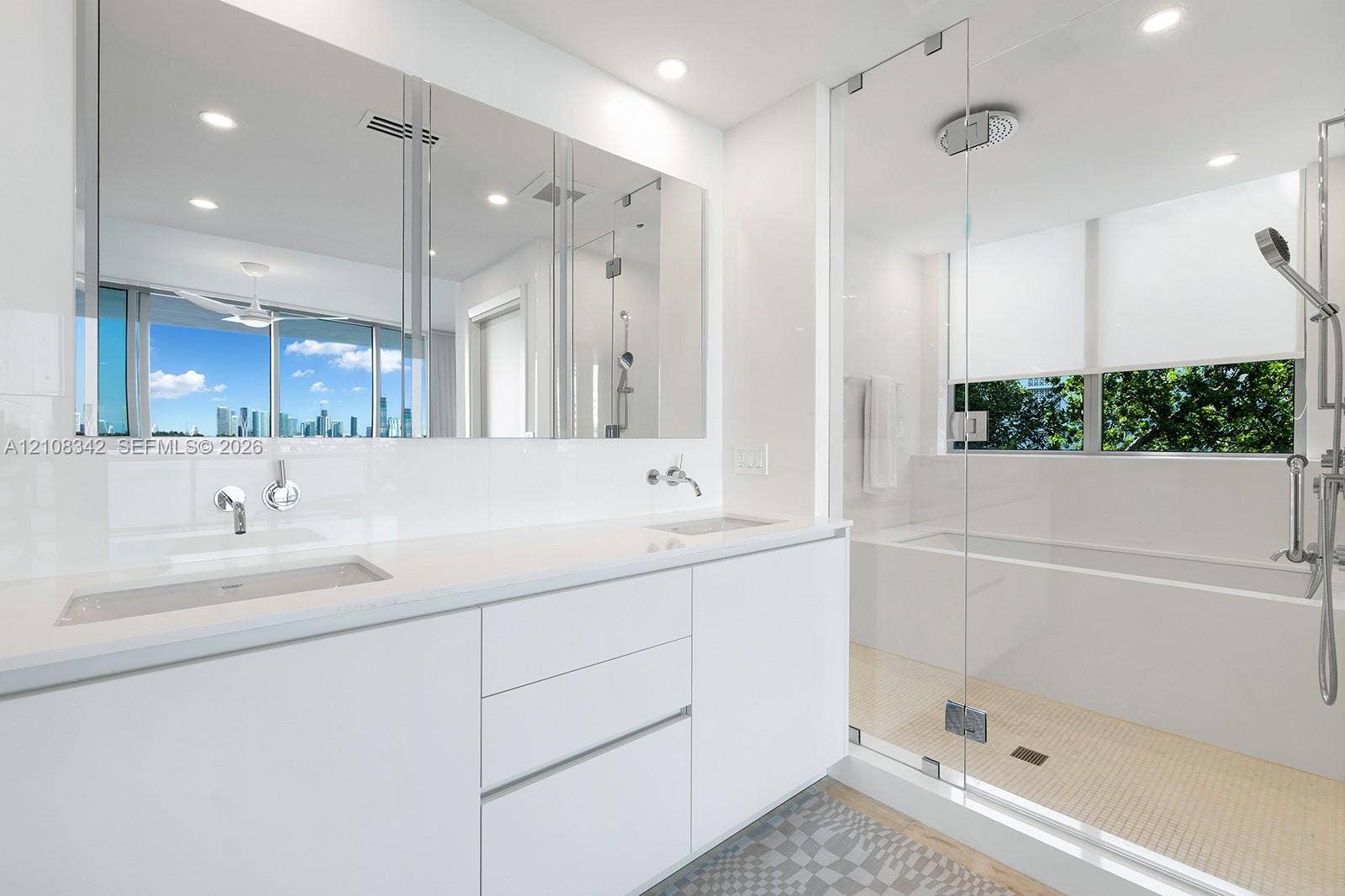 Floating dual-sink vanity with a solid surface countertop, large wall-to-wall mirror, glass-enclosed walk-in shower, built-in soaking tub, and recessed ceiling lighting